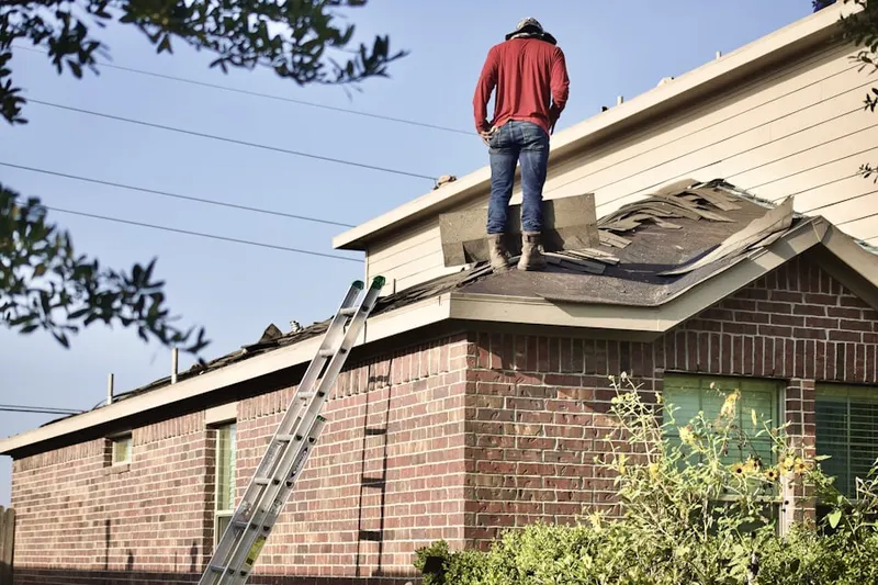Professional roofer working on a residential roof in Juliustown